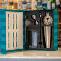 The Complete Cocktail Set featuring tools for crafting cocktails, including shaker, jigger, and strainer in stylish packaging.