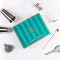 The Complete Cocktail Set displayed with tools like shakers, strainers, and measuring jigger for home bartending fun.